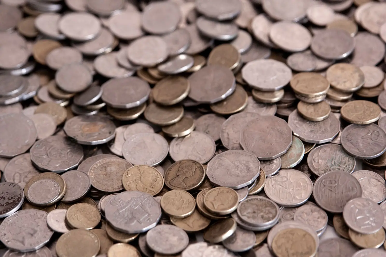 A close view of scattered Australian coins in mixed denominations.